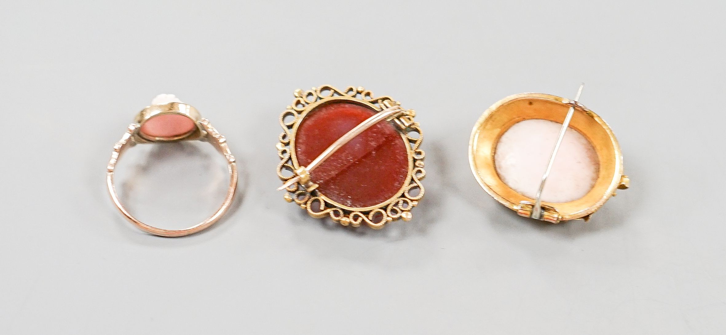 Two yellow metal and cameo set oval brooches, shell and hardstone cameo brooches and a 9ct cameo ring